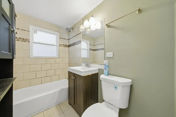 a bathroom with a sink a toilet and bathtub