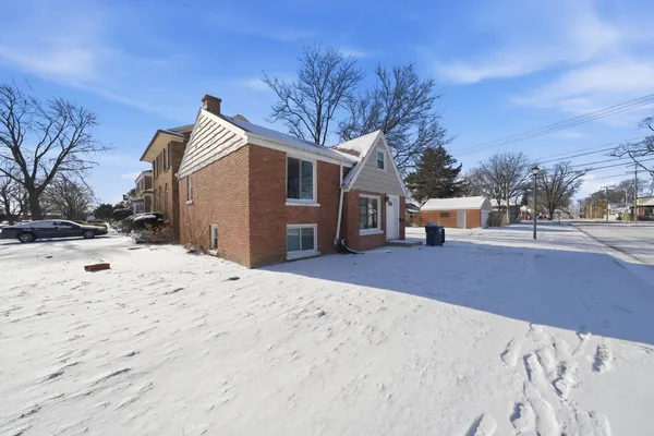 a view of a house with snow on the road