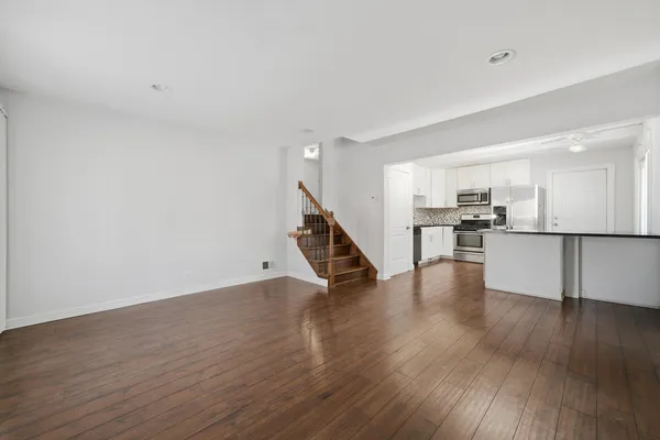 a view of kitchen with wooden floor and electronic appliances
