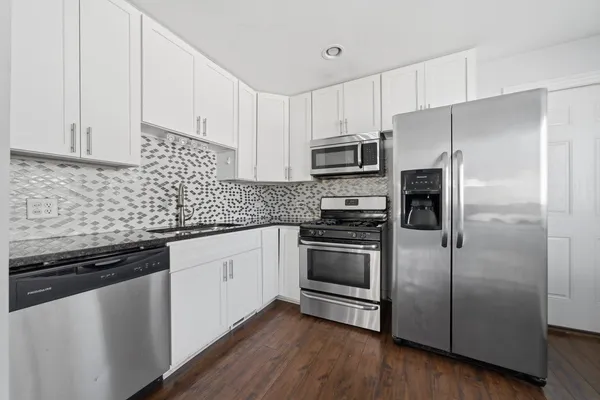a kitchen with stainless steel appliances and wooden cabinets