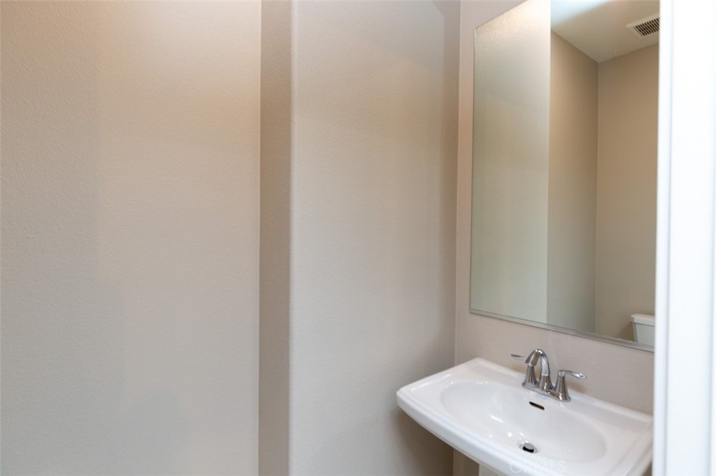 1095 Delpy View Vista Vista, CA 92084 - Photo 12 of 30 a bathroom with a sink and a mirror