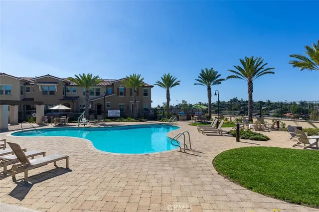 a swimming pool with outdoor seating and yard