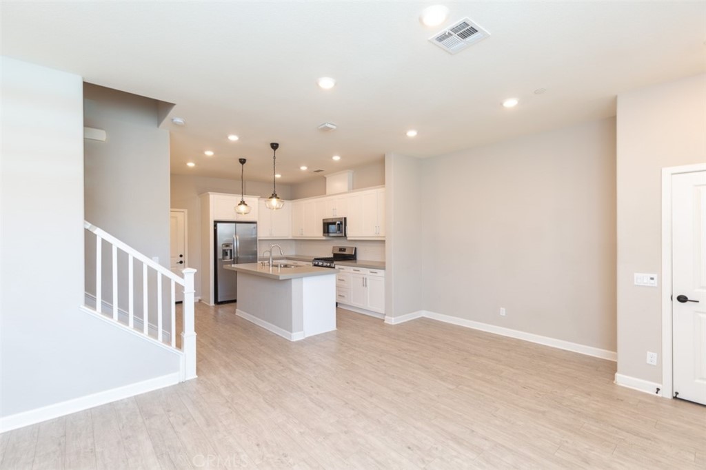 1095 Delpy View Vista Vista, CA 92084 - Photo 9 of 30 a open kitchen with white cabinets and sink