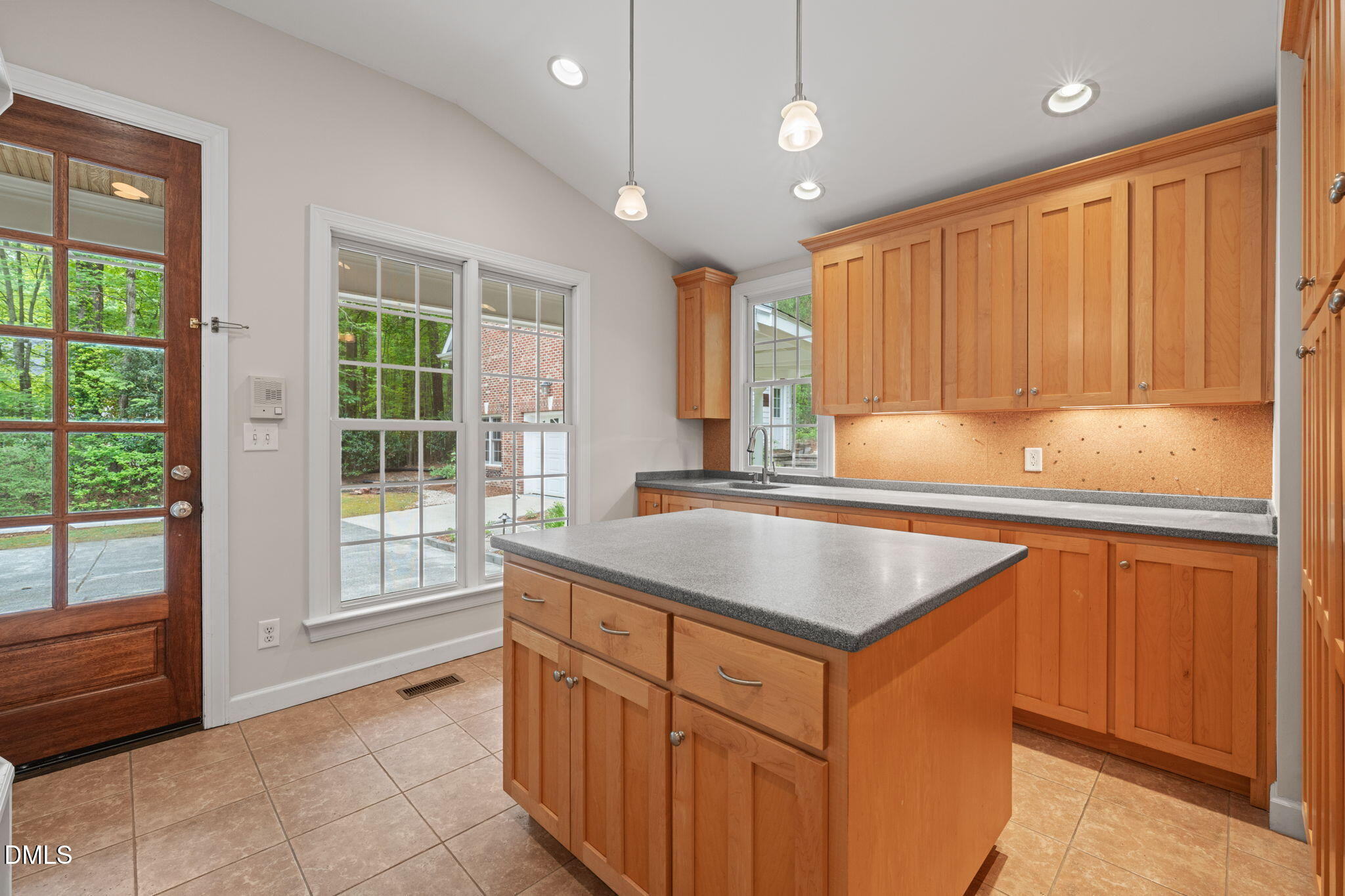 5809 Stone Spring Road Raleigh, NC 27613 - Photo 17 of 54 a kitchen with kitchen island granite countertop a sink and a large window