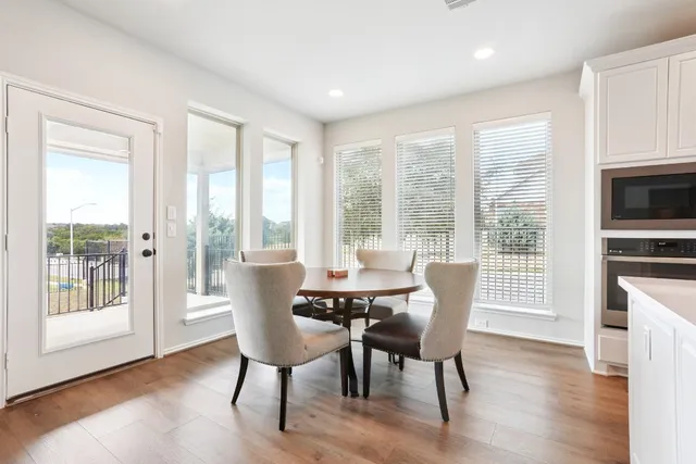 a large kitchen with stainless steel appliances granite countertop a stove and a sink