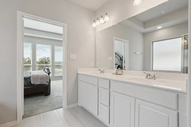 a white bath tub sitting next to a shower