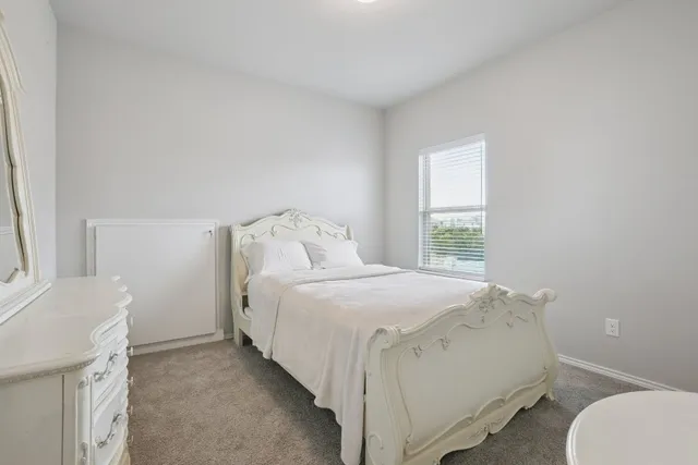 a bedroom with a bed and a dressers