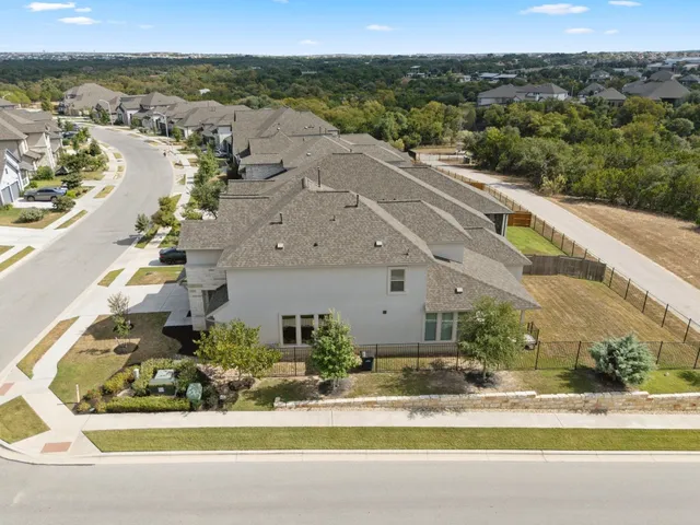 an aerial view of a house with a yard and lake view
