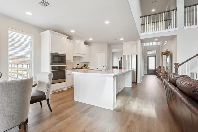 a view of kitchen with cabinets and wooden floor