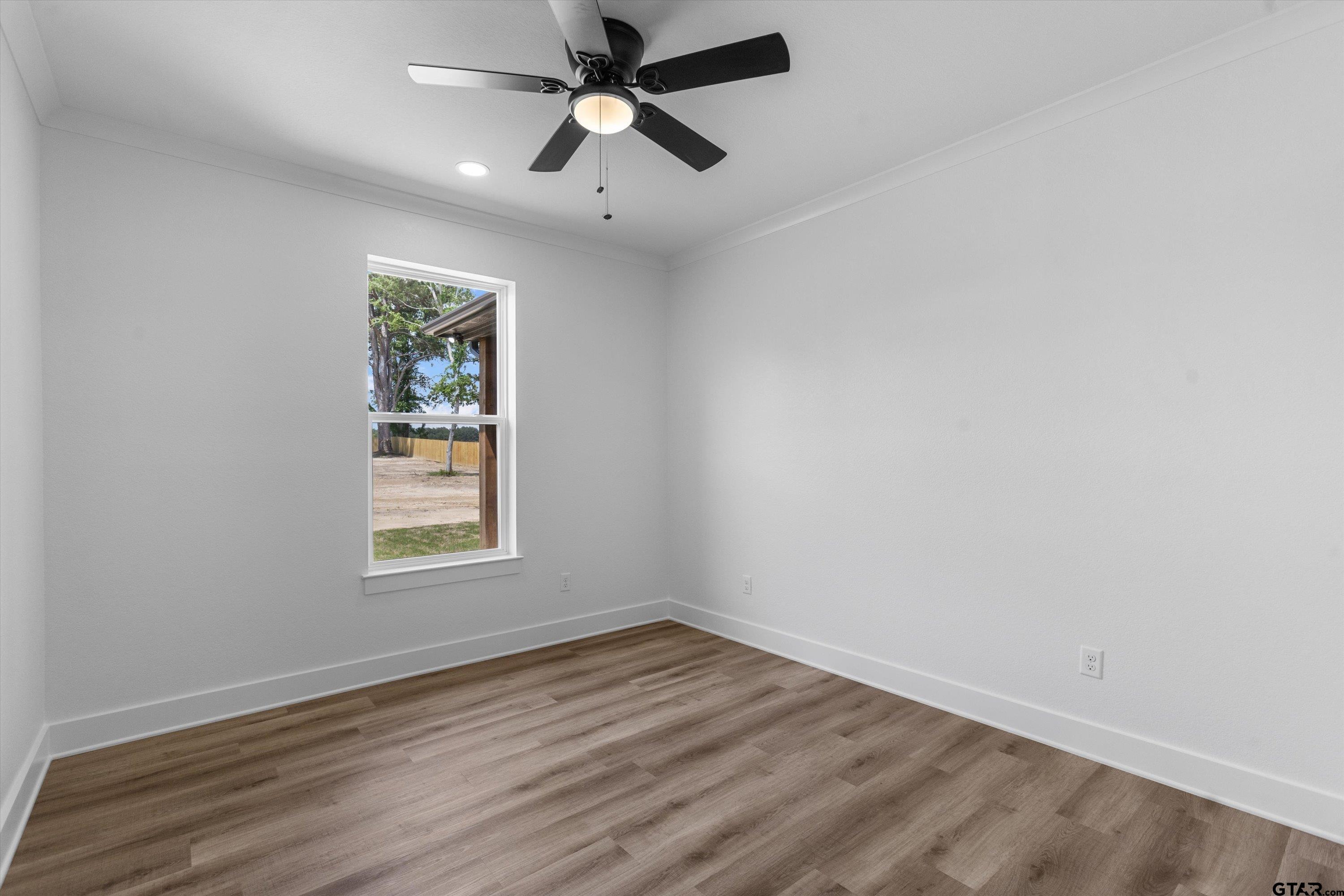 17763 Jayleen Lane Tyler, TX 75707 - Photo 15 of 23 an empty room with wooden floor ceiling fan and windows