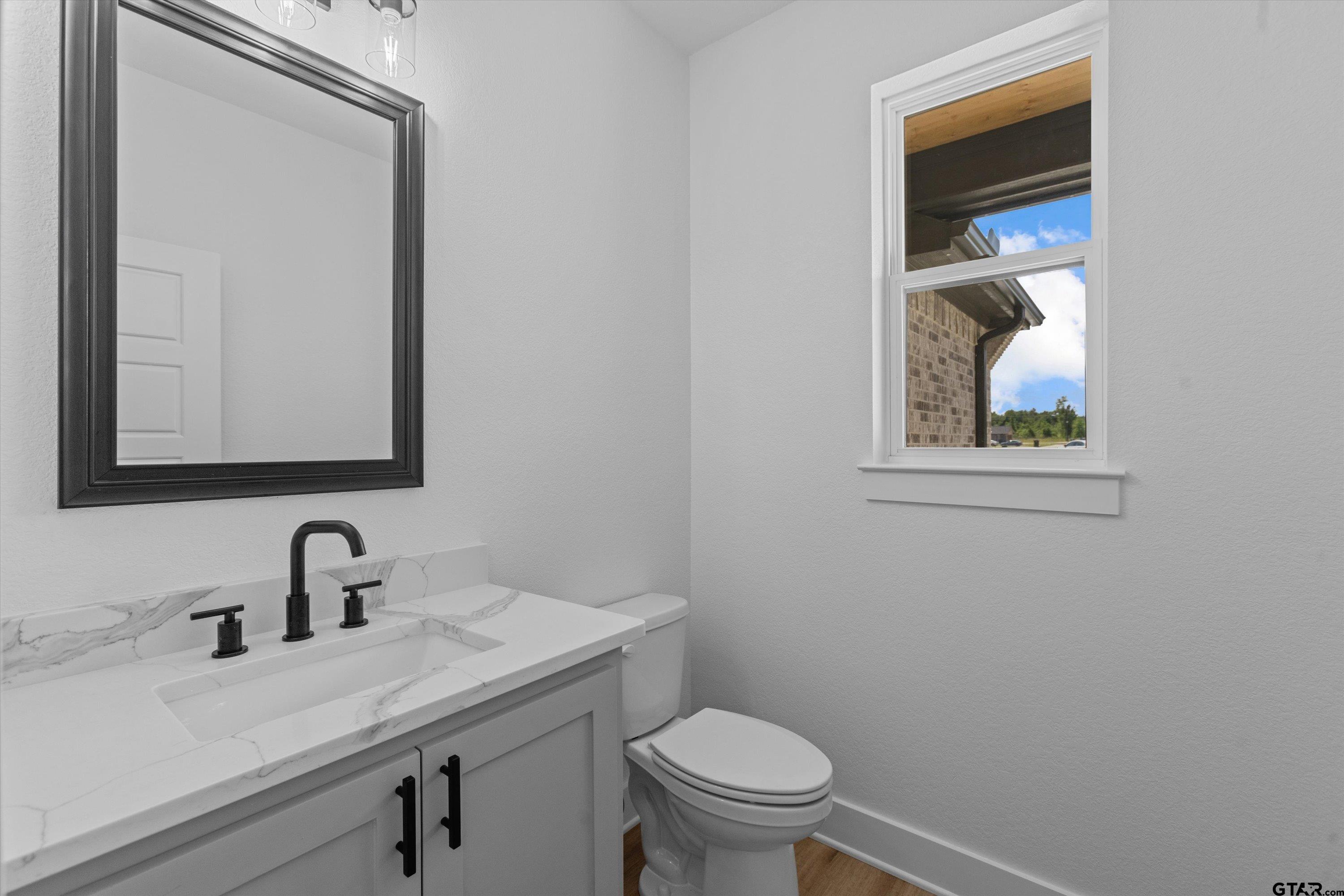 17763 Jayleen Lane Tyler, TX 75707 - Photo 21 of 23 a bathroom with a toilet sink and mirror