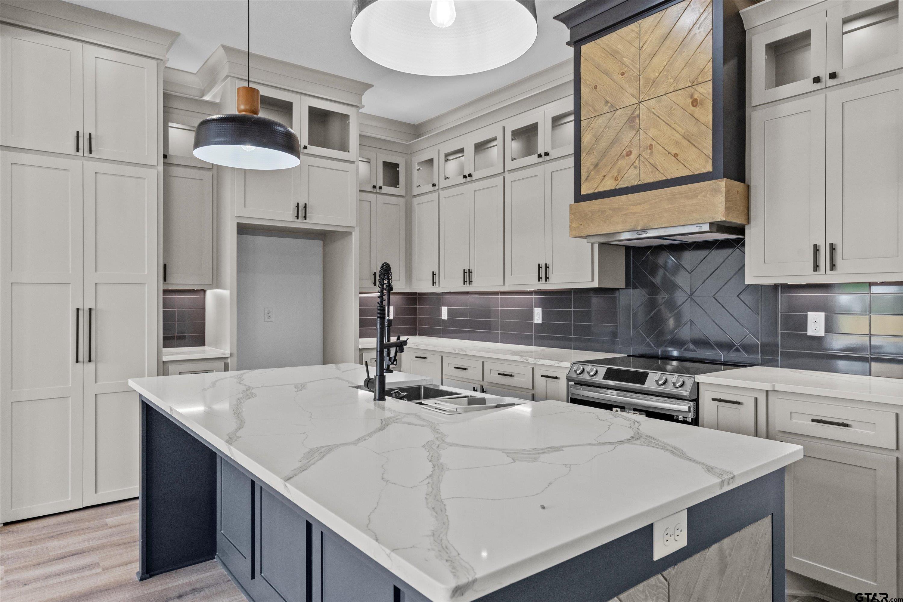 17763 Jayleen Lane Tyler, TX 75707 - Photo 7 of 23 a kitchen with stainless steel appliances granite countertop a sink a stove and a refrigerator