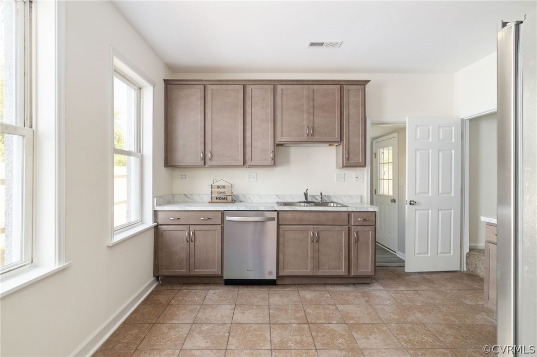 5205 Blue Ridge Avenue Richmond, VA 23231 - Photo 11 of 30 a kitchen with granite countertop white cabinets a sink a window and stainless steel appliances