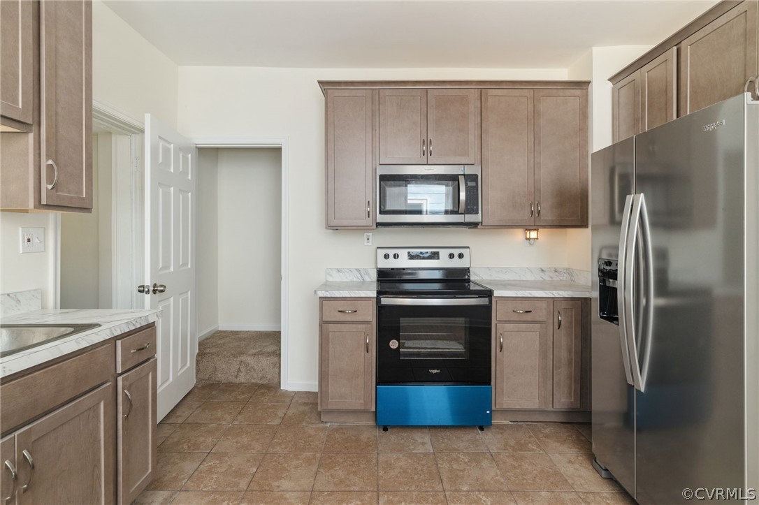 5205 Blue Ridge Avenue Richmond, VA 23231 - Photo 13 of 30 a kitchen with stainless steel appliances and refrigerator