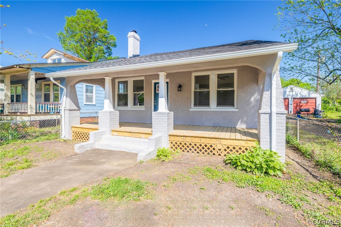 5205 Blue Ridge Avenue Richmond, VA 23231 - Photo 4 of 30 a front view of a house with a yard and potted plants