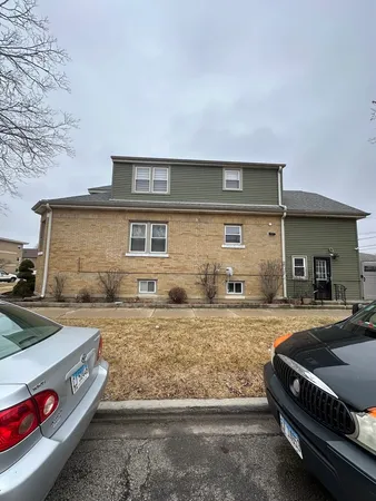 a front view of a house with parking area