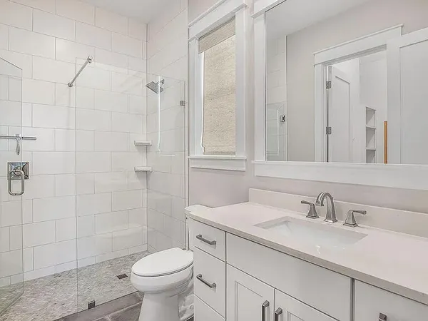 a bathroom with a sink toilet and shower