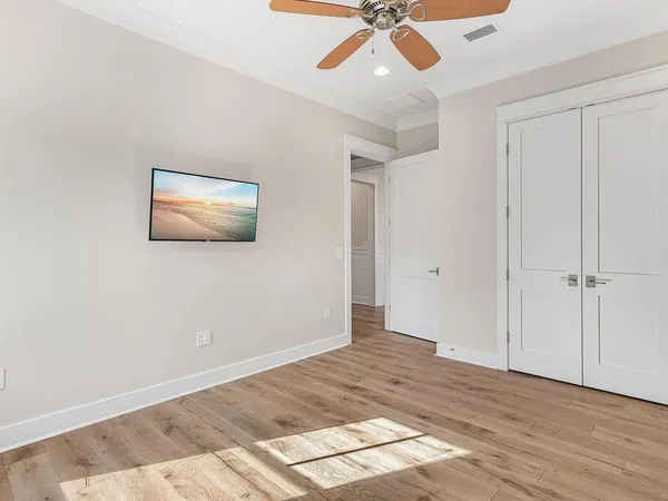 a view of empty room with wooden floor