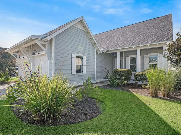 a front view of a house with a garden