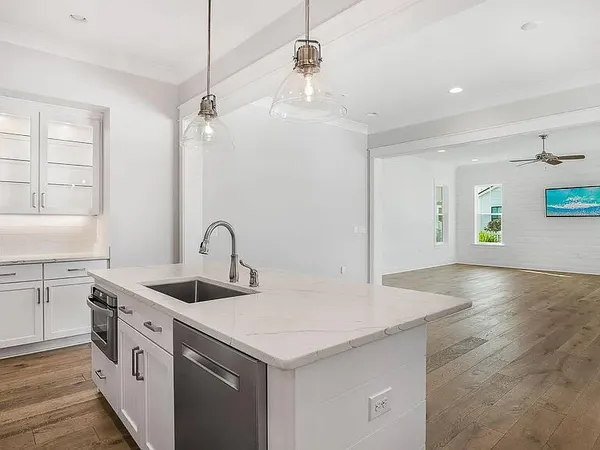 a open kitchen with stainless steel appliances granite countertop a sink a stove and a granite counter tops