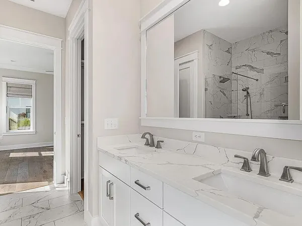 a bathroom with double sink and a mirror