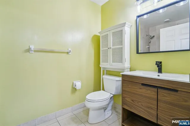 a bathroom with a sink a toilet and mirror