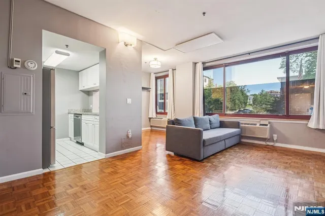 a living room with furniture and a large window
