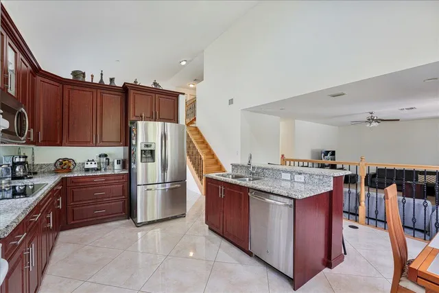 a kitchen with stainless steel appliances granite countertop a stove refrigerator and cabinets