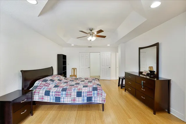 a bedroom with a bed and wooden floor