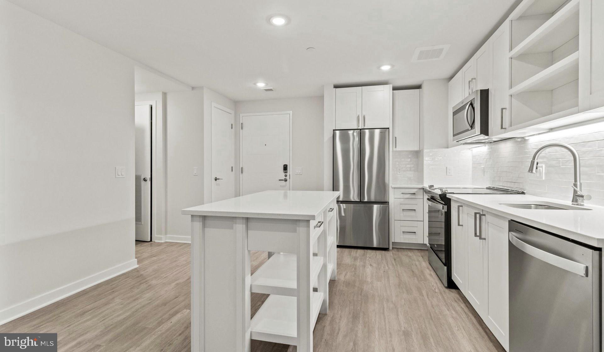 4000 Wisconsin Avenue Northwest, Unit 4K236 Washington, DC 20016 - Photo 31 of 54 a kitchen with a sink a refrigerator a washer and dryer