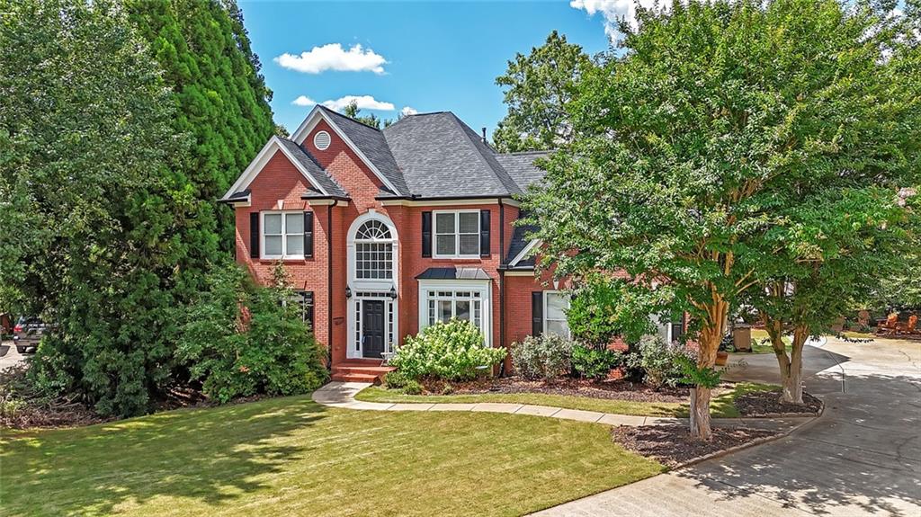 2205 Eagle Trace Cumming, GA 30040 - Photo 1 of 1 a front view of a house with a yard