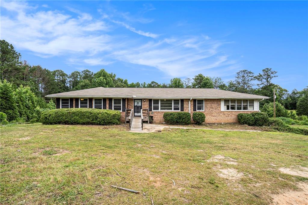 2367 Ridge Road Douglasville, GA 30134 - Photo 1 of 1 a front view of a house with a garden