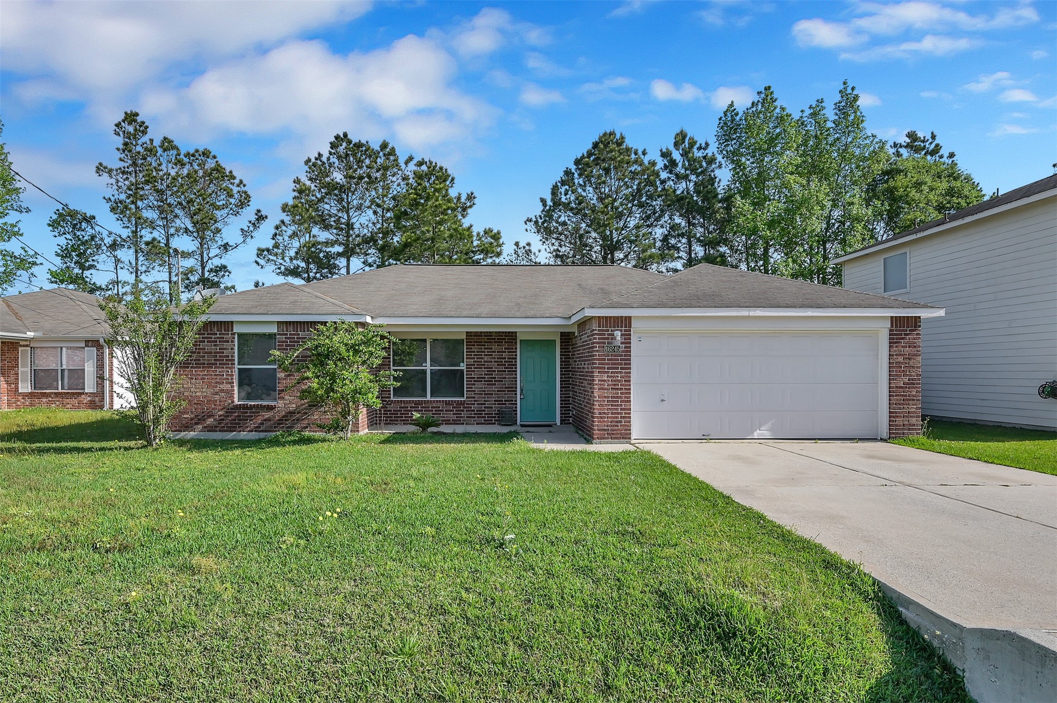 16245 Sun View Lane Conroe, TX 77302 - Photo 1 of 19 a front view of a house with a yard and trees