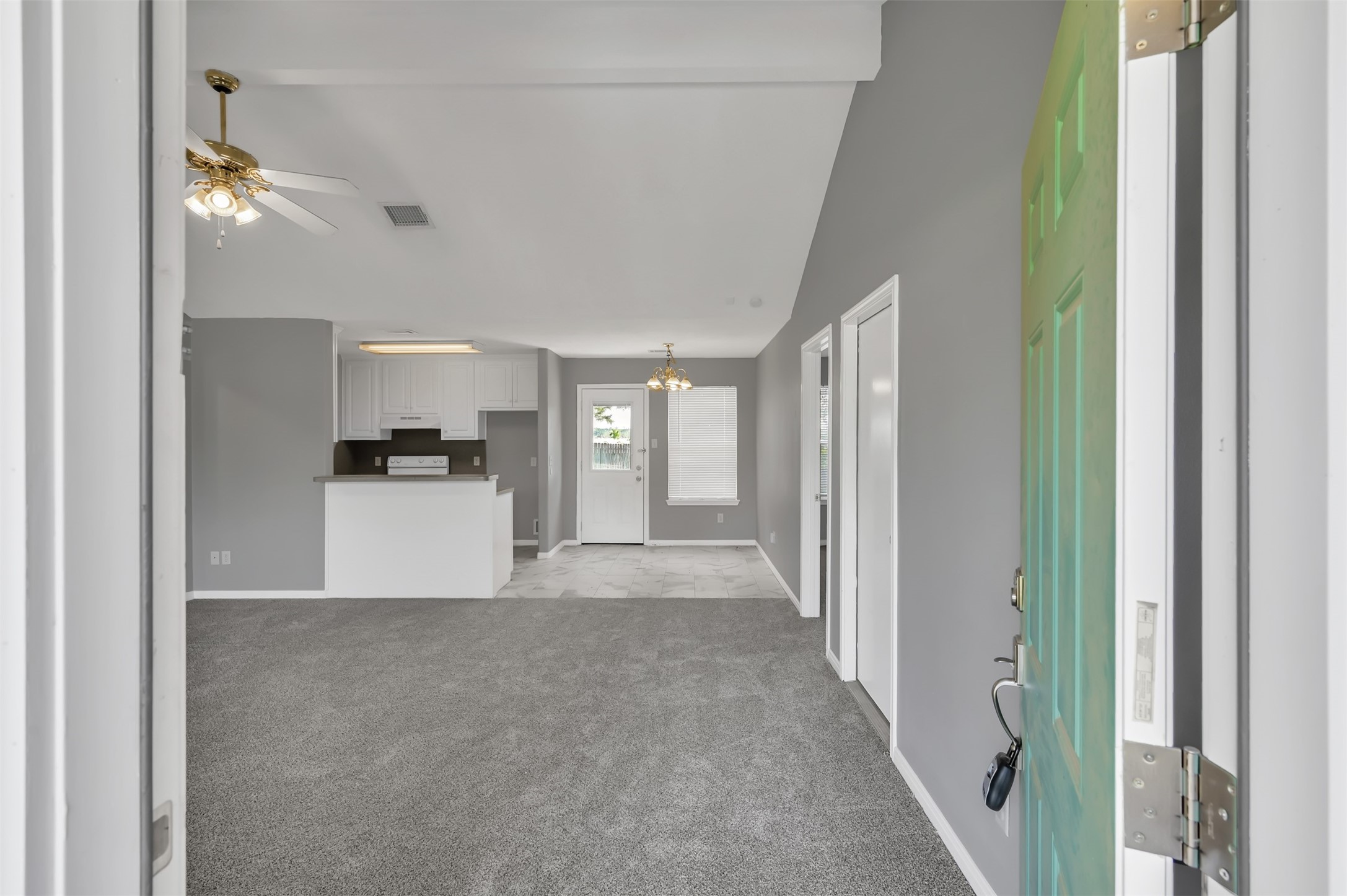 16245 Sun View Lane Conroe, TX 77302 - Photo 3 of 19 a view of a hallway with wooden floor and a living room