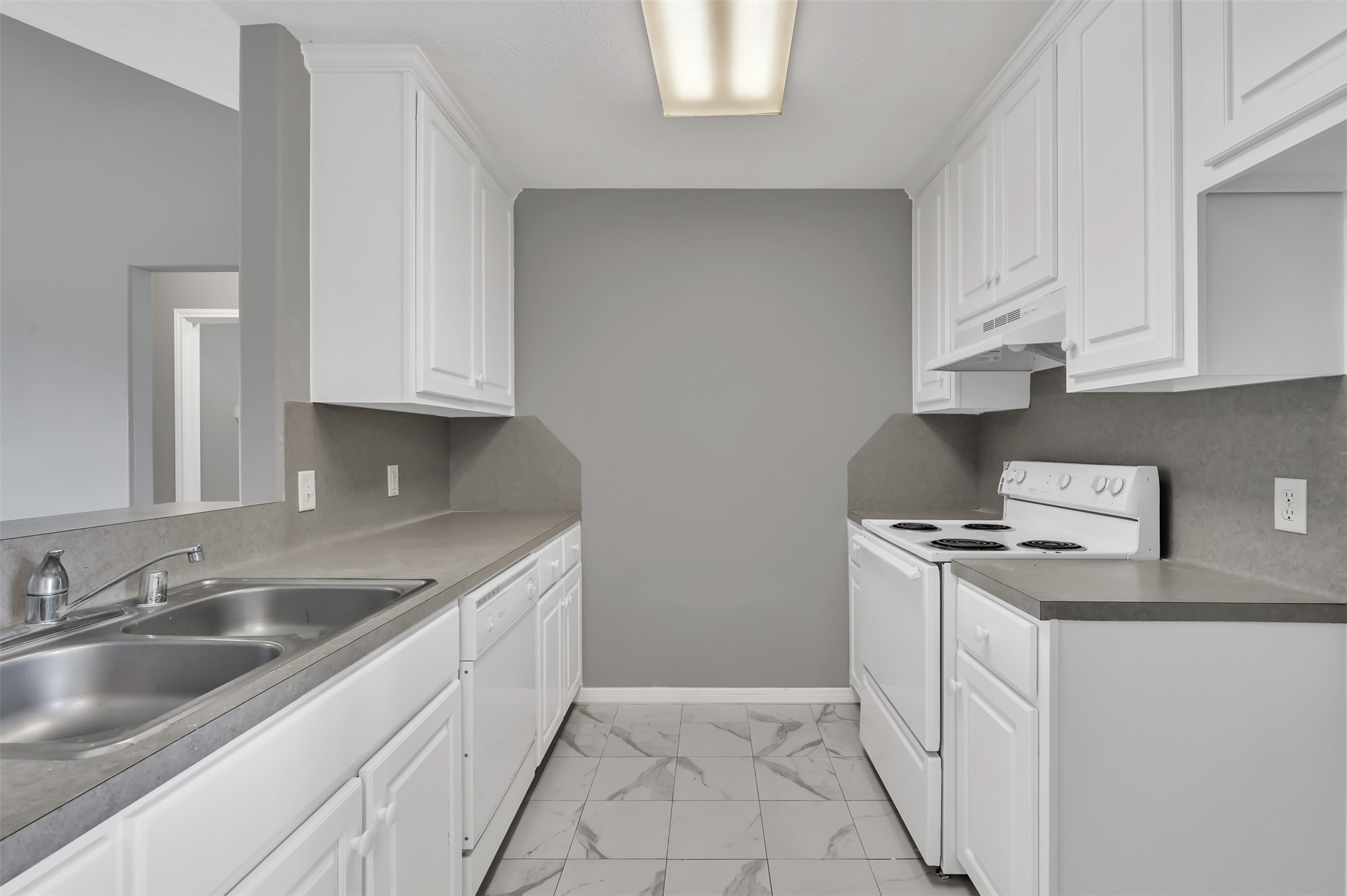 16245 Sun View Lane Conroe, TX 77302 - Photo 7 of 19 a kitchen with granite countertop a sink stove and cabinets