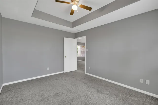 an empty room with a ceiling fan and a ceiling fan
