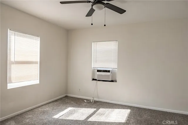 a view of a room with a window and ceiling fan