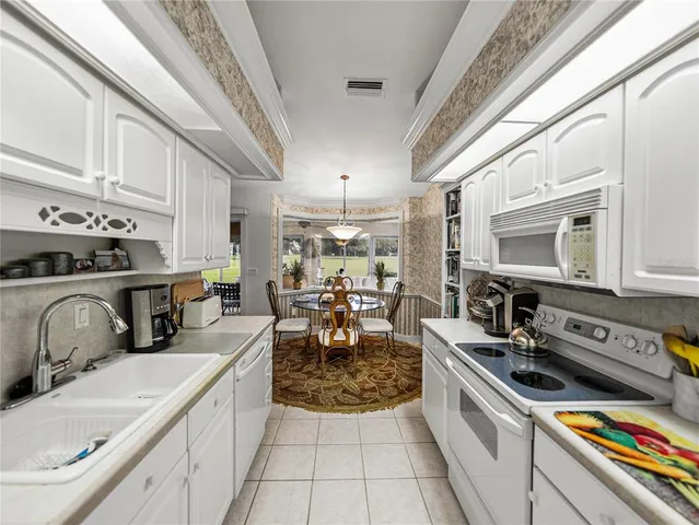 a kitchen with a stove a sink and a refrigerator