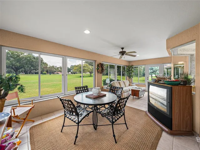 a living room with furniture a rug and a large window