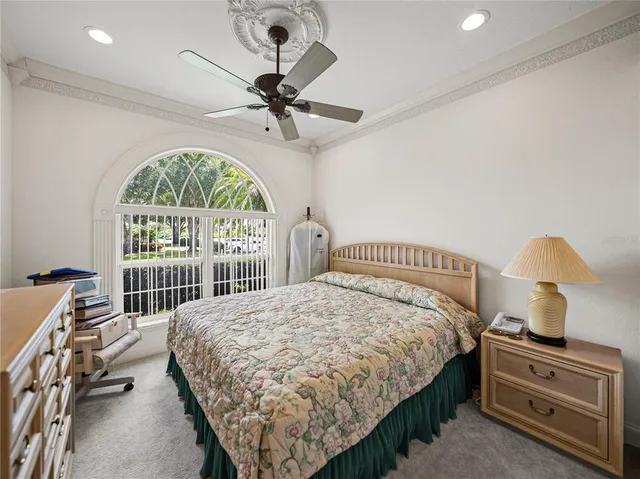 a bedroom with a bed and a large window