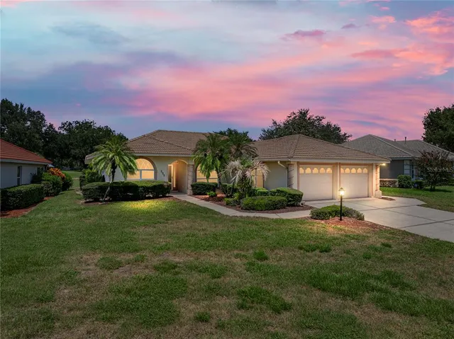 a front view of a house with a garden and a fire pit