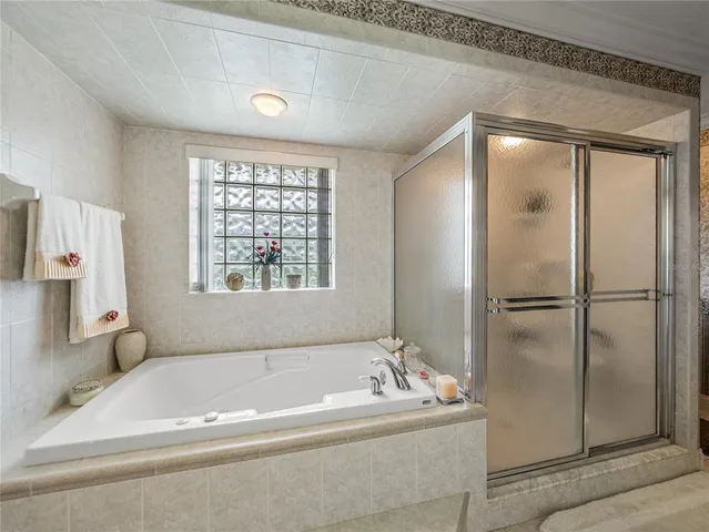a en suite bathroom with a bathtub and a shower