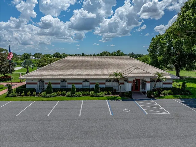 a porch with a table and chairs and potted plants