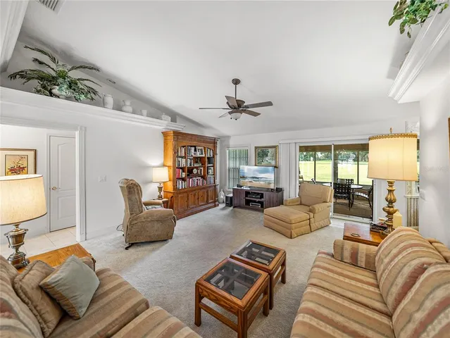 a living room with furniture and a lamp