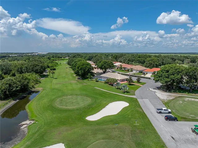 an aerial view of a golf course with chairs