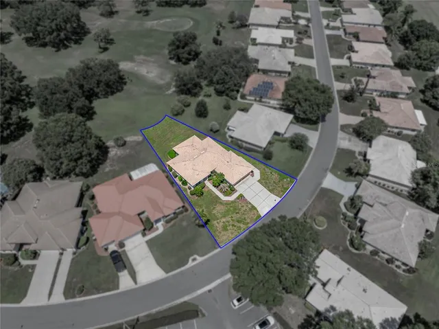 an aerial view of a city with lots of residential buildings and mountain view in back