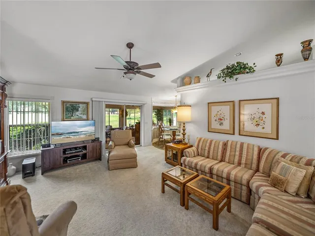 a living room with furniture flat screen tv and window