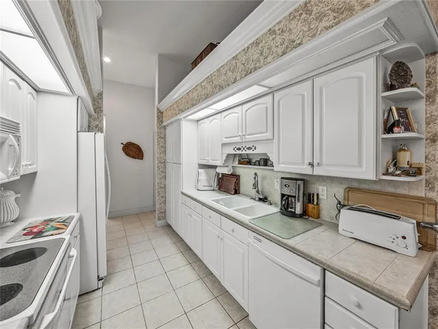 a kitchen with stainless steel appliances granite countertop a sink and cabinets