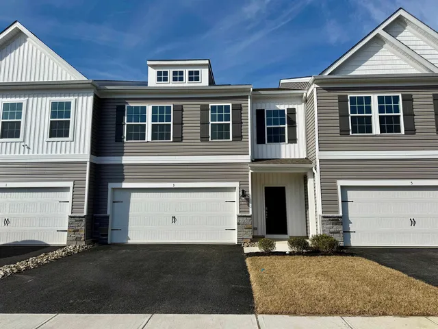 a front view of a house with yard