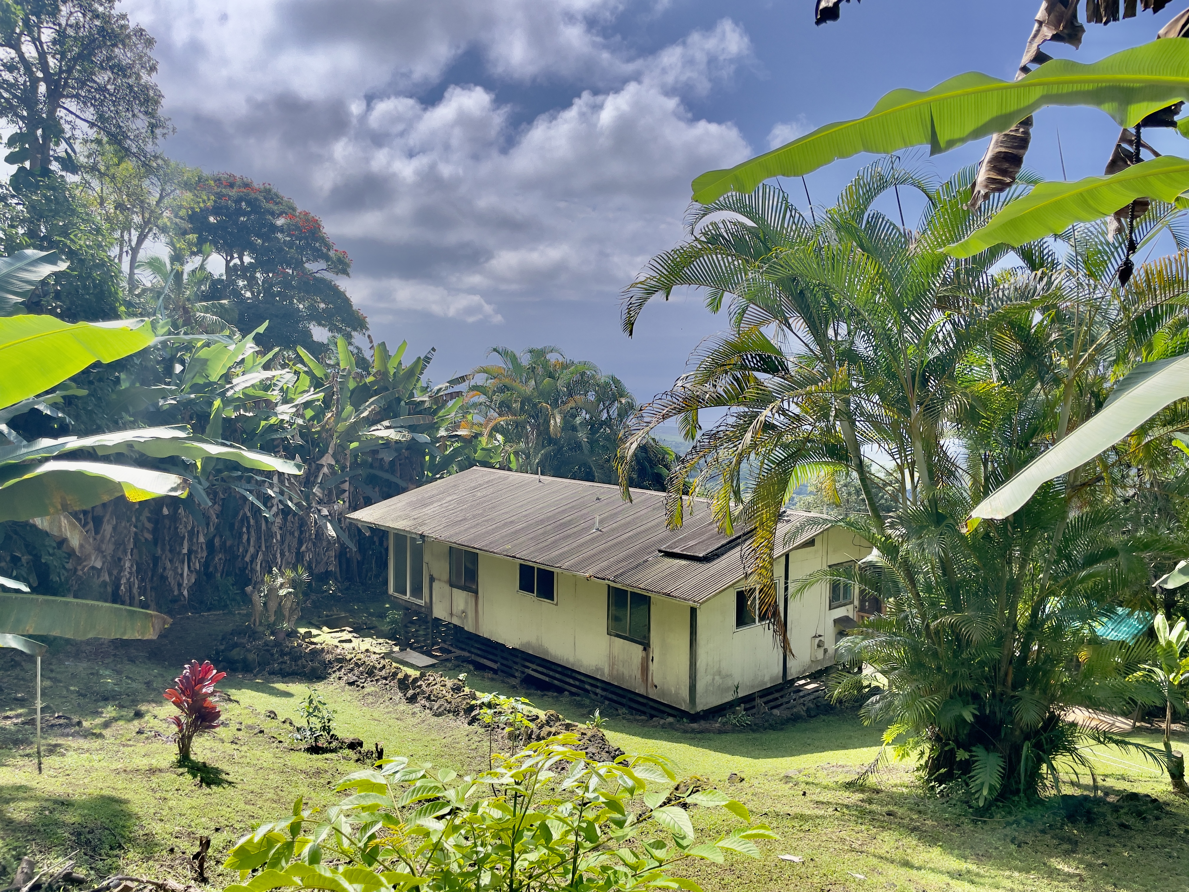 83-5586 Hawaiʻi Belt Road Captain Cook, HI 96704 - Photo 17 of 23 a view of a house with a yard and garden